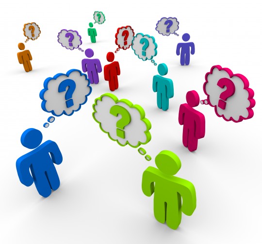 Many colorful people stand in a crowd thinking of questions